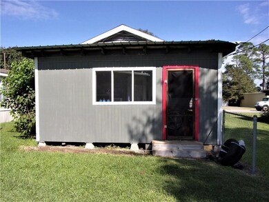 Back Exterior of Cottage:  Covered, patio area.