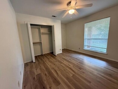 Unfurnished bedroom featuring wood finished floors, a ceiling fan, and a closet