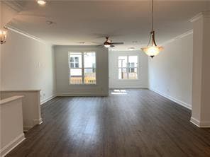 Unfurnished living room featuring crown molding, dark wood-type flooring, and a ceiling fan
