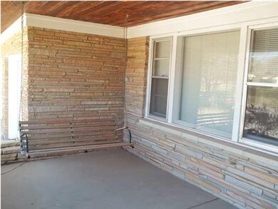 Large covered front porch with swing and natural s