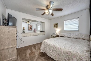 Carpeted bedroom with a textured ceiling and ceili