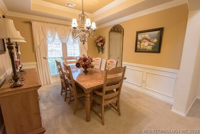 Formal dining has tray ceiling and wainscoting.