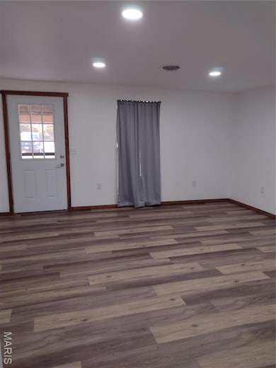 Foyer featuring wood finished floors and recessed lighting