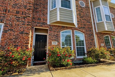 Gated entry with beautifully landscaped grounds, scenic pond, and walking paths in the Lakeridge Townhomes community.