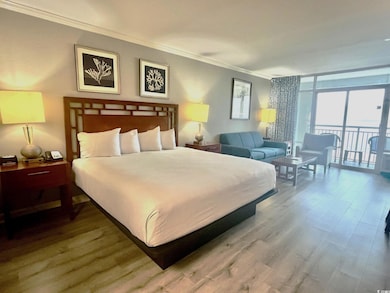 Bedroom with access to exterior, crown molding, a wall of windows, and wood-type flooring