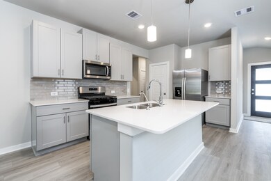 Modern kitchen with white granite countertops and