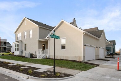 View of front of home with concrete driveway, a front yard, stucco siding, and roof with shingles