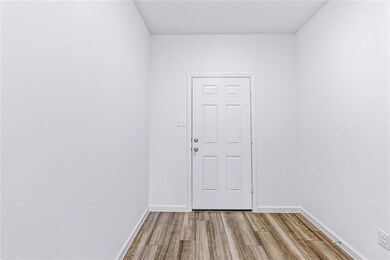 Open foyer with wood laminate flooring