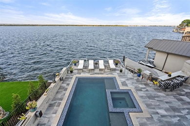 View of swimming pool with a water view, a patio,