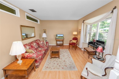 Living room with bay window overlooking front yard