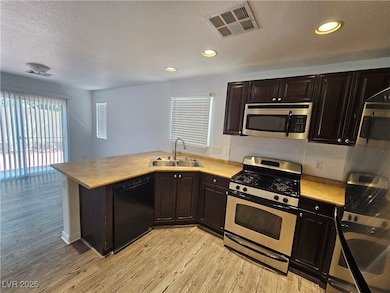 Kitchen featuring stainless steel appliances, ligh