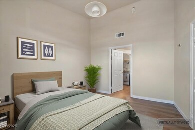 Bedroom with wood finished floors and a towering c