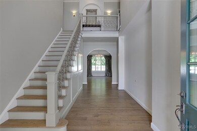 2 story Foyer, arched entry to the diningroom base