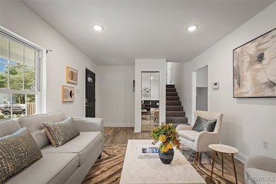 Living area with wood finished floors, baseboards,