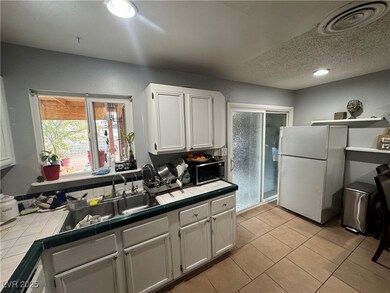 Kitchen featuring white cabinetry, visible vents,