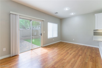 Unfurnished room with light wood-style floors, hea