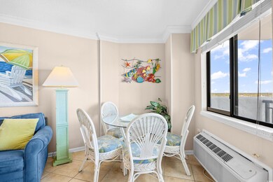 Tiled dining area featuring crown molding, baseboa