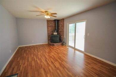 Great room with wood burning stove and doors which