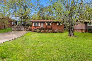 This home sits on a large flat lot and has beautiful mature trees.