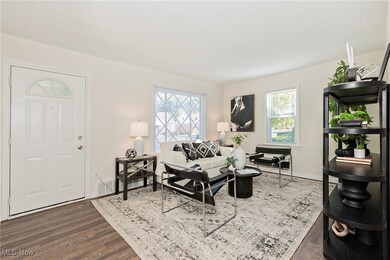 Living area featuring plenty of natural light and dark wood-type flooring