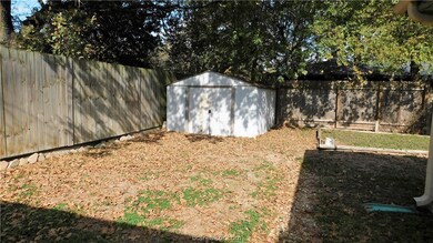 Large over-sized yard with storage building.