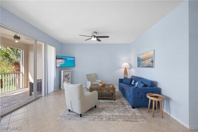 Living room with light tile patterned floors and ceiling fan