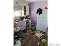 Kitchen featuring freestanding refrigerator