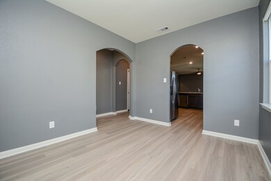 This room can be used as a dining room, study, or office space.