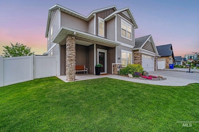 View of front of house with stone siding, board and batten siding, concrete driveway, and a porch