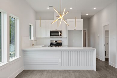 Kitchen Area With Waterfall Island And Modern Fini