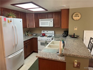 Kitchen with kitchen peninsula, white appliances,