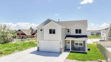 View of front of home featuring stone siding, roof with shingles, a garage, and driveway