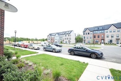 View of asphalt road featuring street lighting, sidewalks, and a residential view