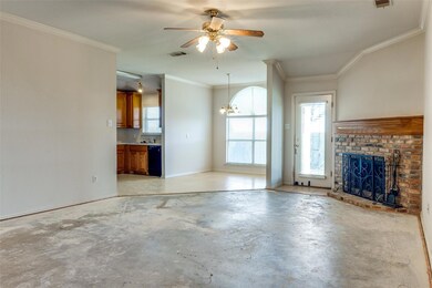 Living room with ornamental molding, a brick firep