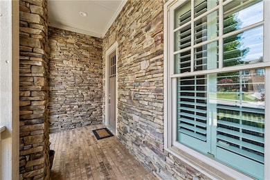 Doorway to property featuring stone siding