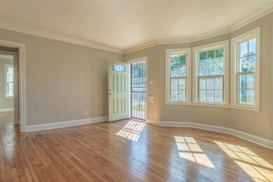 Living room with crown molding, hardwood  flooring