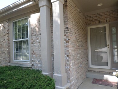 Taupe brick on front and sides of house