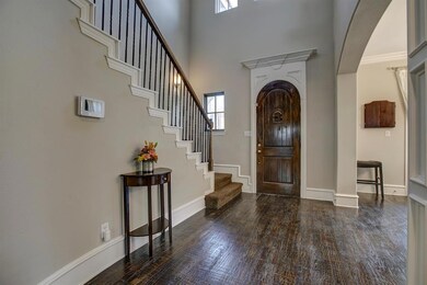 Rich handscraped hardwoods in this wide and welcom