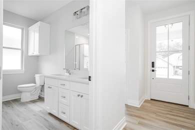 Bathroom with toilet, a healthy amount of sunlight