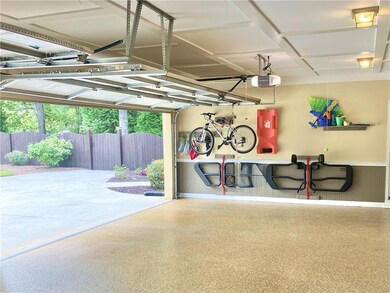 Garage with a wainscoted wall and a garage door opener
