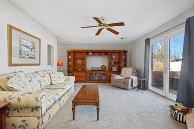Living room featuring light carpet, visible vents,