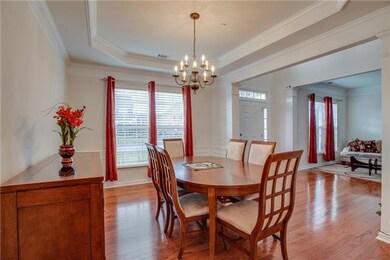 Separate 11' x 14' dining room offering trey ceiling and hardwood floors.