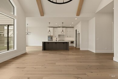 Unfurnished living room with a chandelier, recessed lighting, and light wood-style floors