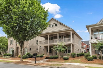 View of front facade featuring a balcony and brick siding