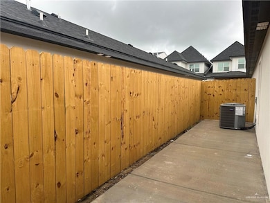 View of patio featuring central air condition unit and fence