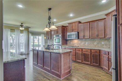 wonderful cabinets with lots of storage. The island is huge and there is also a serving bar leading to great room