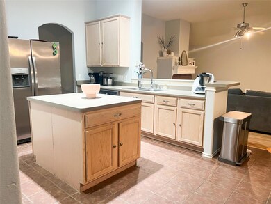 Kitchen with stainless steel refrigerator with ic