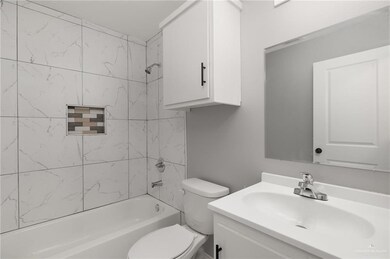 Bathroom with vanity, toilet, and tub / shower combination