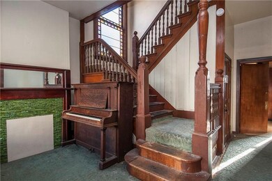 Large foyer with original woodwork and stained gla