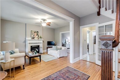 Inviting entrance hall looks into living and dinin